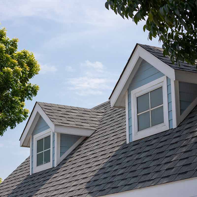 Close up of a residential roof with gray shingles